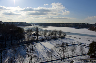Fototapeta na wymiar A snowy, cold and sunny view of jettys at Kungsholmen in Stockholm