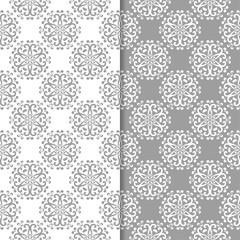 White and gray floral backgrounds. Set of seamless patterns