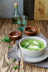 Green peas and broccoli soup . Wooden background, Scandinavian style
