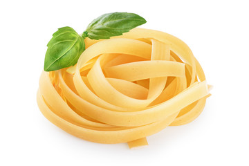 Raw tagliatelle pasta and basil isolated on white background.
