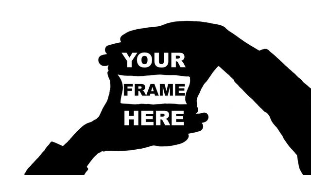 Moving male hands frame gesture with the inscription "Your frame here" Black silhouette of two male hands holding fingers in a frame gesture appears simultaneously with the inscription Your frame here