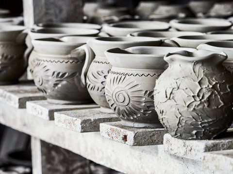 Unfinished clay pots on shelves as part of a ceramic pottery workshop in Marginea, Bucovina, Suceava county, Romania
