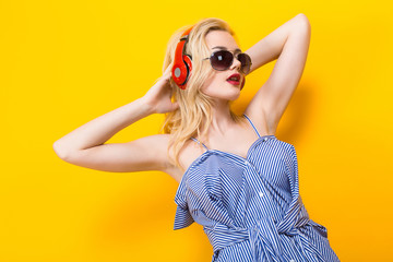 Girl in blouse with headphones and sunglasses