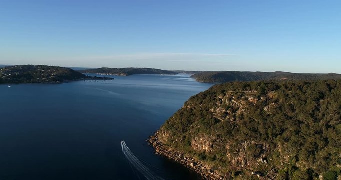 Flying away from rocky cliff on West Head landmass towards Sydney pacific coast in Ku-ring-gai chase national park.
