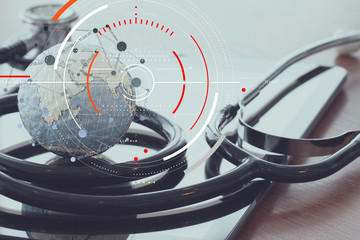 Concept of target focus digital diagram and Graph interfaces with connections netwoork.Medical  stethoscope and texture globe with digital tablet as medical network concept