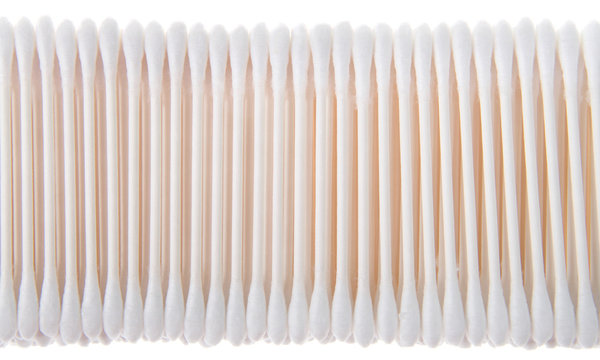 cotton swabs on sticks stacked and lined up in a row. Isolated on white background. commonly used in a variety of applications including first aid, cosmetics application, cleaning, and arts and crafts