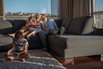 Obraz premium happy young couple spending time with kids at home