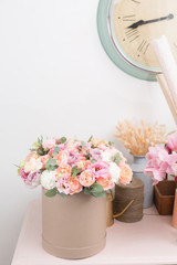 beautiful luxury bouquet of mixed flowers in kraft box. the work of the florist at a flower shop.