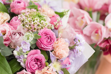 Close-up beautiful luxury bouquet of mixed flowers in glass vases. the work of the florist at a flower shop. Wallpaper