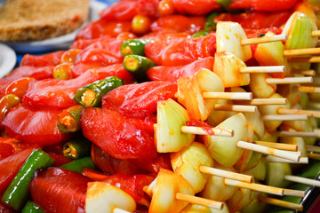 raw chicken with onion and pepper on wooden sticks