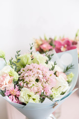 flower shop concept. Close-up beautiful lovely bouquet of mixed flowers on wooden table. Wallpaper