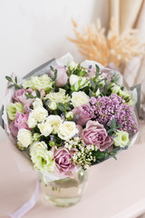 flower shop concept. Close-up beautiful luxury bouquet of mixed flowers on wooden table. Wallpaper