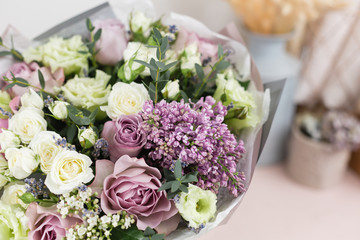 flower shop concept. Close-up beautiful luxury bouquet of mixed flowers on wooden table. Wallpaper