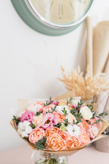 flower shop concept. Close-up beautiful luxury bouquet of mixed flowers on wooden table. Wallpaper