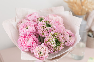 Persian buttercup. lace with many petals. Bunch pale pink ranunculus flowers light background. Wallpaper