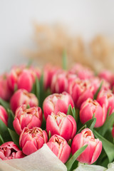 close-up. beautiful luxury bouquet of pink tulips flowers on table. the work of the florist at a flower shop.