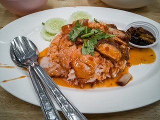 Barbecued red pork in sauce with rice.