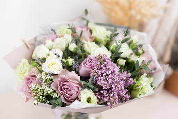 flower shop concept. Close-up beautiful luxury bouquet of mixed flowers on wooden table. Wallpaper