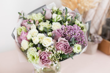 flower shop concept. Close-up beautiful luxury bouquet of mixed flowers on wooden table. Wallpaper