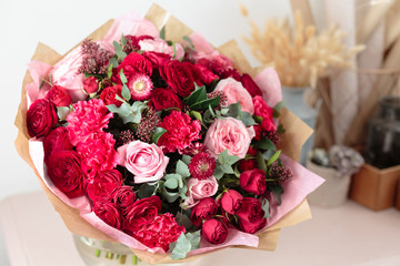 Close-up beautiful luxury bouquet of mixed red and pink flowers in glass vases. the work of the...