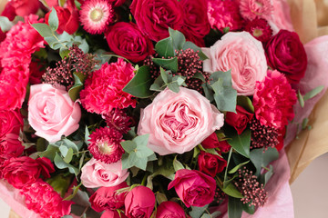 Close-up beautiful luxury bouquet of mixed red and pink flowers in glass vases. the work of the florist at a flower shop. Wallpaper