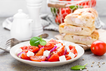 Tomato salad with fresh red onion and feta cheese. Healthy eating