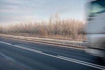 A winter road with a speeding truck