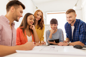 creative team with blueprint working at office