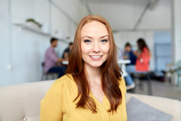 happy creative female worker at office or student