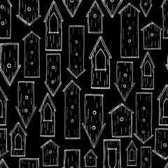 Seamless pattern with hand drawn ink birdhouses. Strokes on black background.