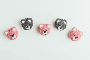 top view of sweet tasty muffins in shape of bears isolated on grey