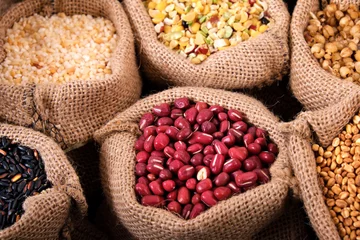 Selbstklebende Fototapeten Red beans and various grains in sack © jc_studio