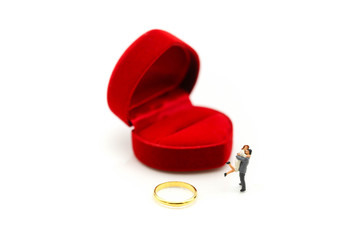 Miniature people : Couple of love with gold ring , love, valentine day concept.