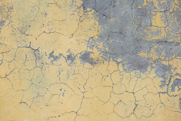 An old yellow paint on a concrete wall.