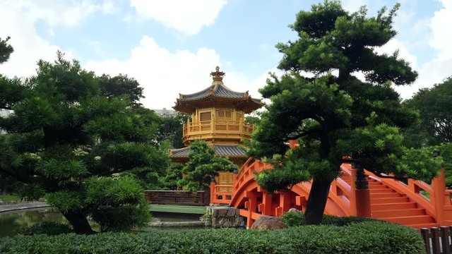 a gimbal shot walking towards the bridge and pavilion of absolute perfection in nan lian gardens in hong kong, china