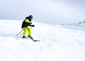Fototapeta na wymiar Mountain skiing, child boy skiing down the mountain