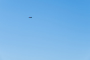 Red-and-white plane flying through the sky to land.