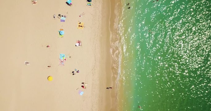 Aerial Footage From Flying Drone Of People Crowd Relaxing On Beach In Portugal