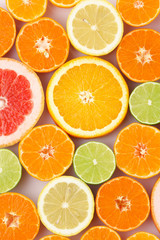 Citrus fruits background mix flat lay. Texture of sliced citrus closeup view.