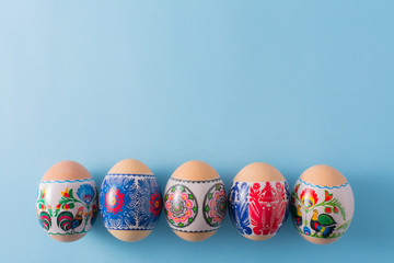 Fototapeta premium easter eggs on blue background with copy space