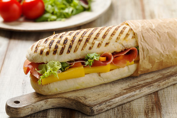 Traditional Italian sandwich with ham and cheese served warm.