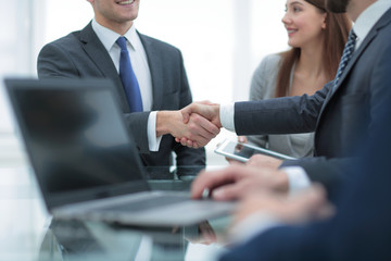 Business colleagues sitting at a table during a meeting with two