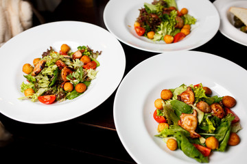 Cheese ball under hazelnut with mix of salad