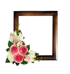 Pink roses and freesia flowers in a corner arrangement with wooden frame