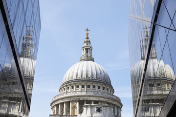 LONDON - MAY, 2017: The dome of St Pauls Cathedral seen between modern buildings, London, EC4.