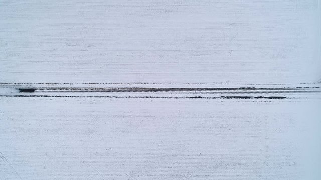 Aerial Shot Of A Snowy Grownd With Train Passing, Symetry Footage.