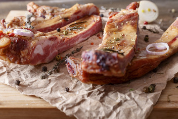 Appetizing smoked pork ribs on a wooden surface