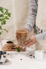 Ice coffee with fresh coffee on a wooden background, Coffee with milk and ice on natural wooden