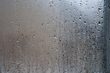 Water vapor and water drops on the glass. abstract background on window