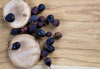 Berries of a dogrose on a wooden background.